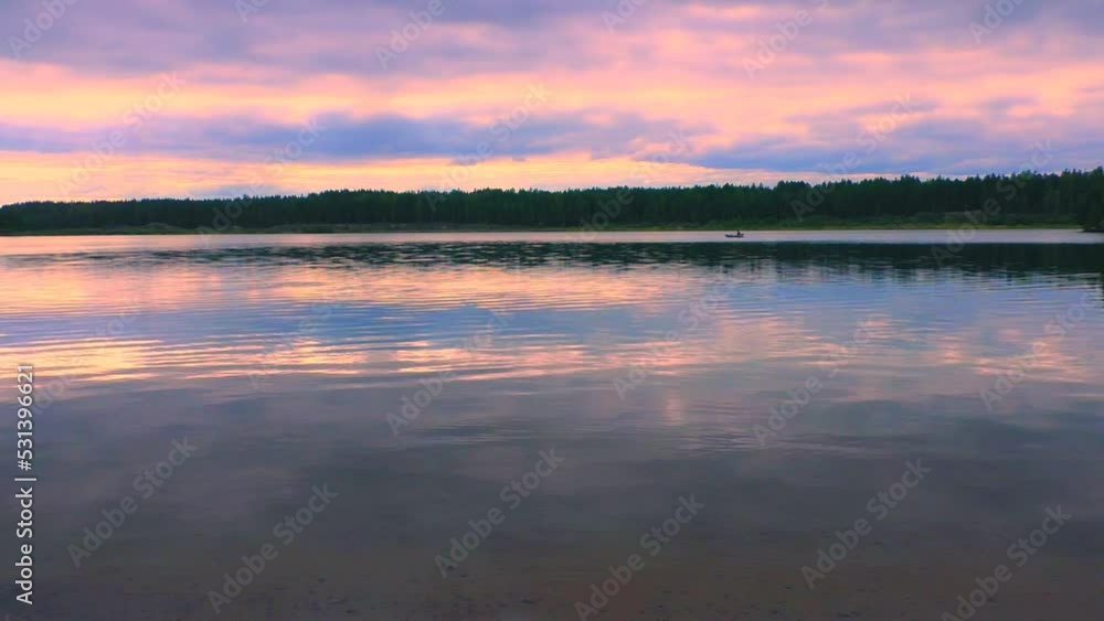 Sunset landscape on the river with a fisherman in a boat. Beautiful wildlife of the North. Sunset landscape on the river with a fisherman in a boat. Beautiful wildlife of the North.