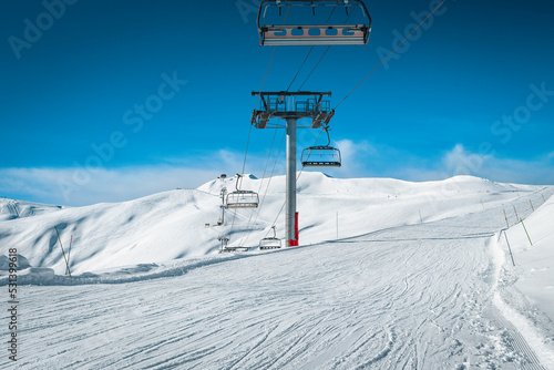 Empty ski lifts on the snowy slopes, La Toussuire, France