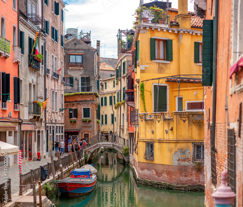 Obraz na płótnie View on the narrow cozy streets of the canals with parked boats in Venice, Italy. Architecture and landmark of Venice. w salonie