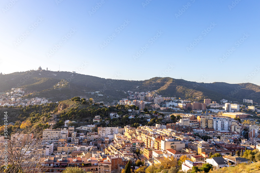 Barcelona skyline at sunny day. City landscape view from the mountain.