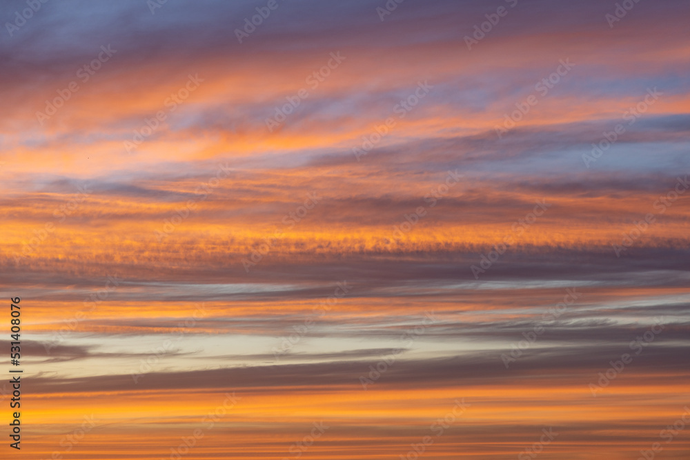 Orange lit clouds during sunset