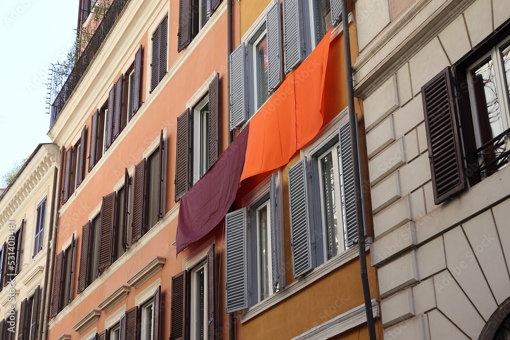 Typical Building Facades in Rome with A.S. Roma Football Team Colors Hanging from a Window, Italy