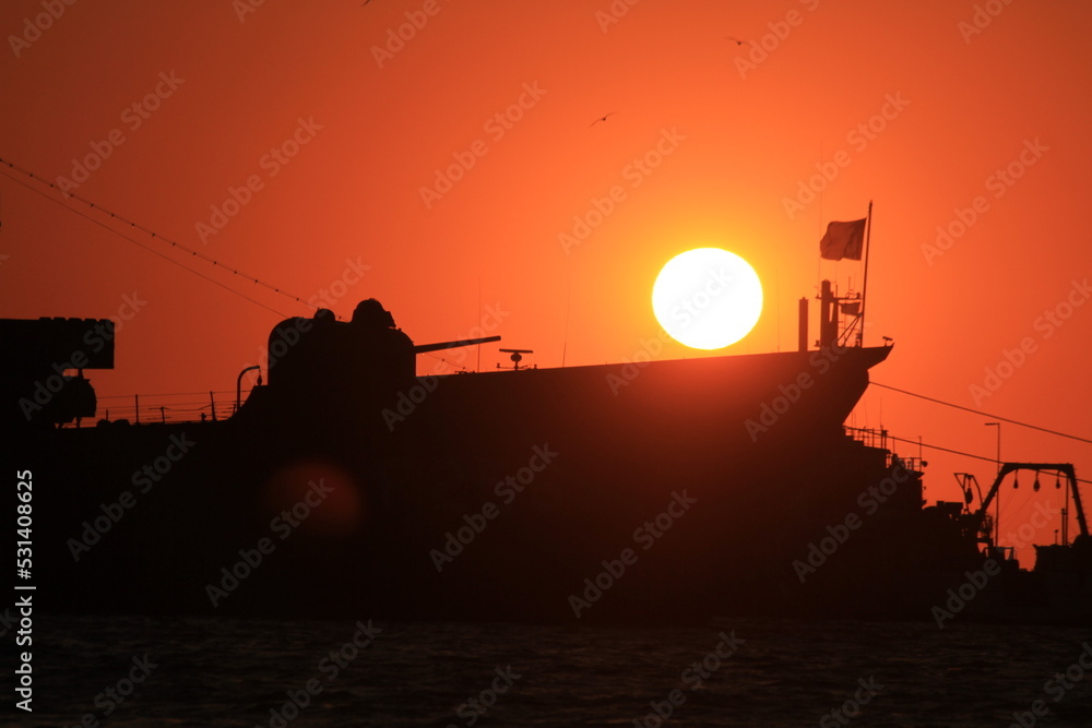 sunset over military ship
