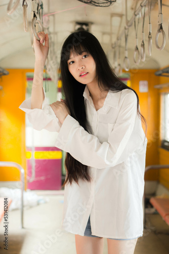 Portrait of thai japan adult beautiful girl white shirt blue jeans relax time, train station fashion
