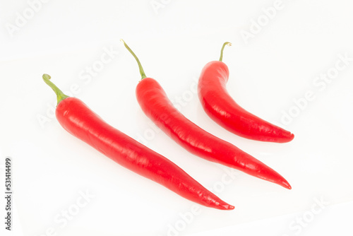 3 red hot natural chili peppers. Fresh organic  chili pepper isolated on white.