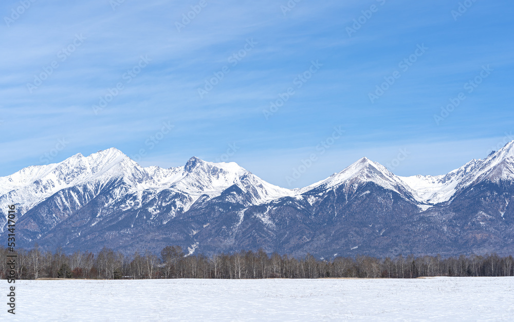 Winter landscape with Sayan Mountains in Siberia on sunny winter day. Natural background.