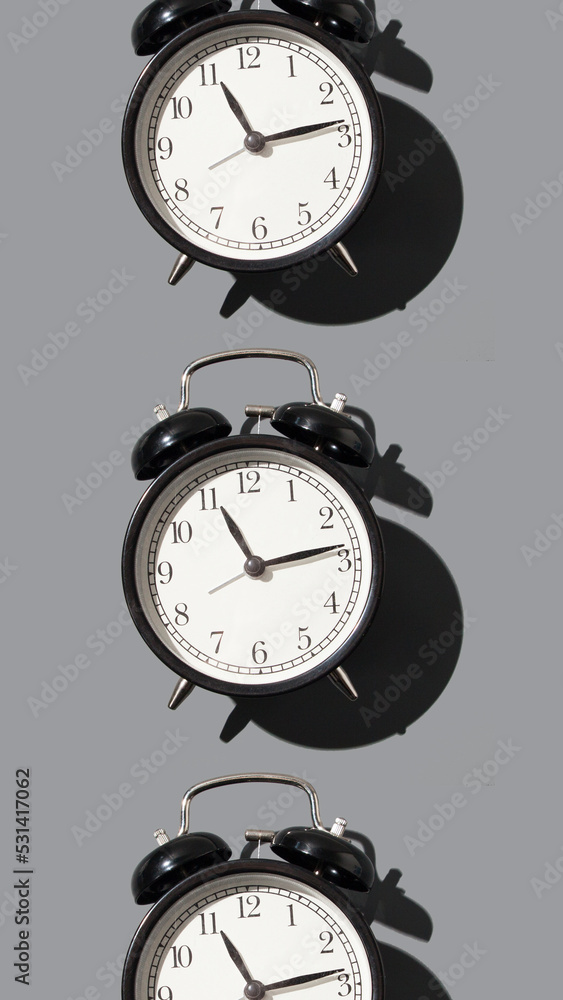 black alarm clock on gray background pattern black alarm clock on gray background pattern