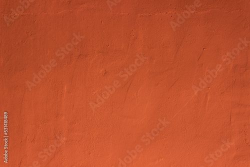 Dark brownish terracotta plaster rough wall texture background	 photo
