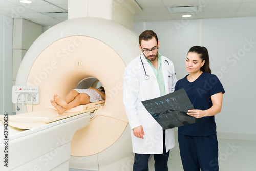 Technician and nurse looking at the resonance results of a patient at the laboratory