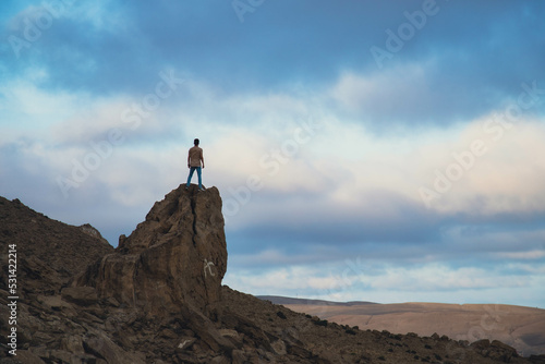 silhouette of a person on a rock