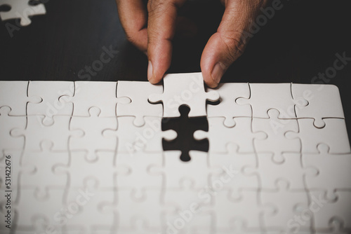 Business woman person hand with puzzle piece idea for strategy and solution. Closeup part of two white jigsaw connect together. Concept of join cooperation success teamwork-problem corporate team.