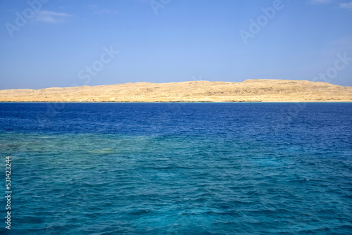 Vacation, travel, holiday, trip to Egypt. View from Red sea to deserted sandy island against clear blue sky. Copy space. Selective focus.