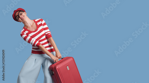Woman carrying a heavy suitcase photo