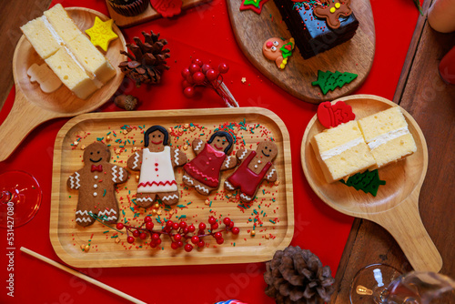 Ginger bread family ready on Christmas dinner table.