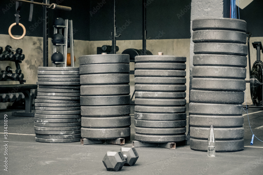 pile of weights on a gym floor pile of weights on a gym floor