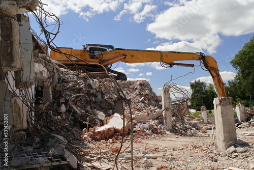 An excavator during the demolition of a building