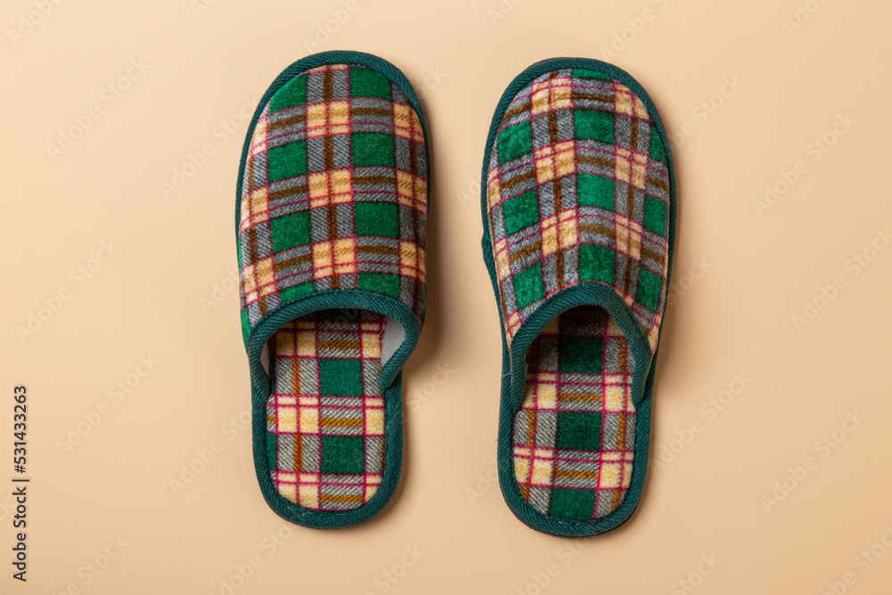 a house checkered slippers on a beige background a house checkered slippers on a beige background