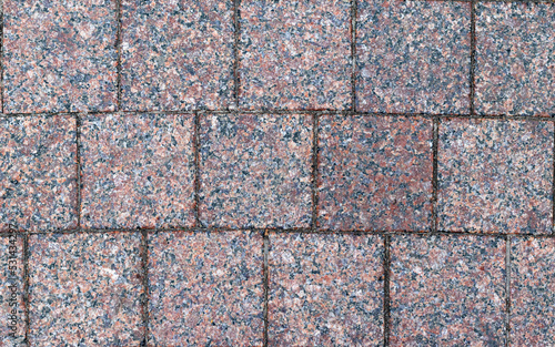 The texture of the sidewalk paved with stone  which can be used as a background. The texture of the stone.