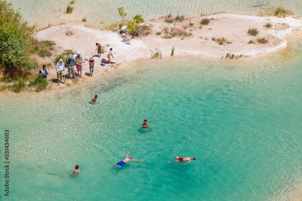 Band-e Amir National Park (Band-i Amir lakes), local tourists visiting the blue and turquoise lakes and friends swimming together, Bamyian Province, Afghanistan
