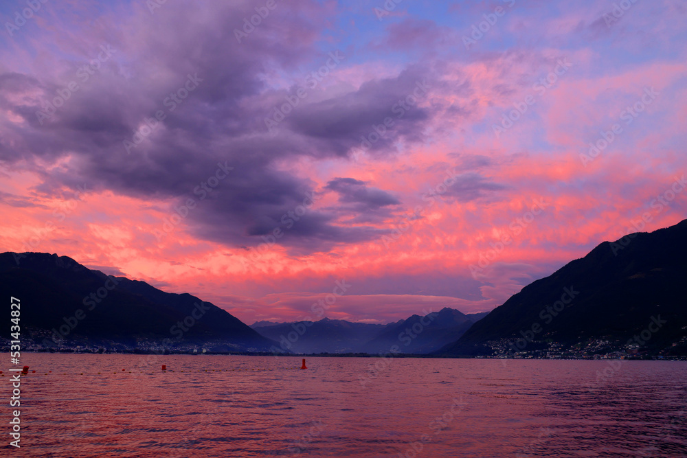 Lake Maggiore at sunset against the Alps, Locarno, Switzerland, Europe Lake Maggiore at sunset against the Alps, Locarno, Switzerland, Europe