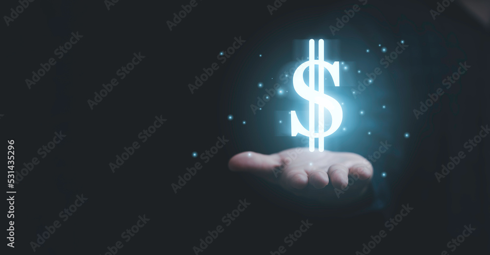 Businessman holding glowing USD dollar sign for currency exchange and money transfer concept , USD from united of America and it main money exchange in the world. - obrazy, fototapety, plakaty 