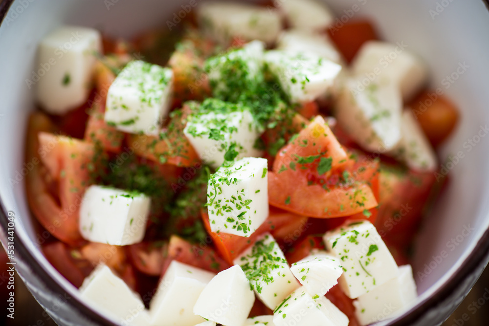 salad of fresh ripe tomatoes with mozzarella and spices in a bowl salad of fresh ripe tomatoes with mozzarella and spices in a bowl