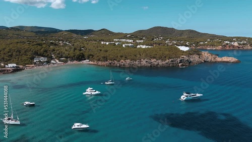 aerial shot of sailing yachts beach bay beautiful Mediterranean blue water view on the balearic islands of ibiza