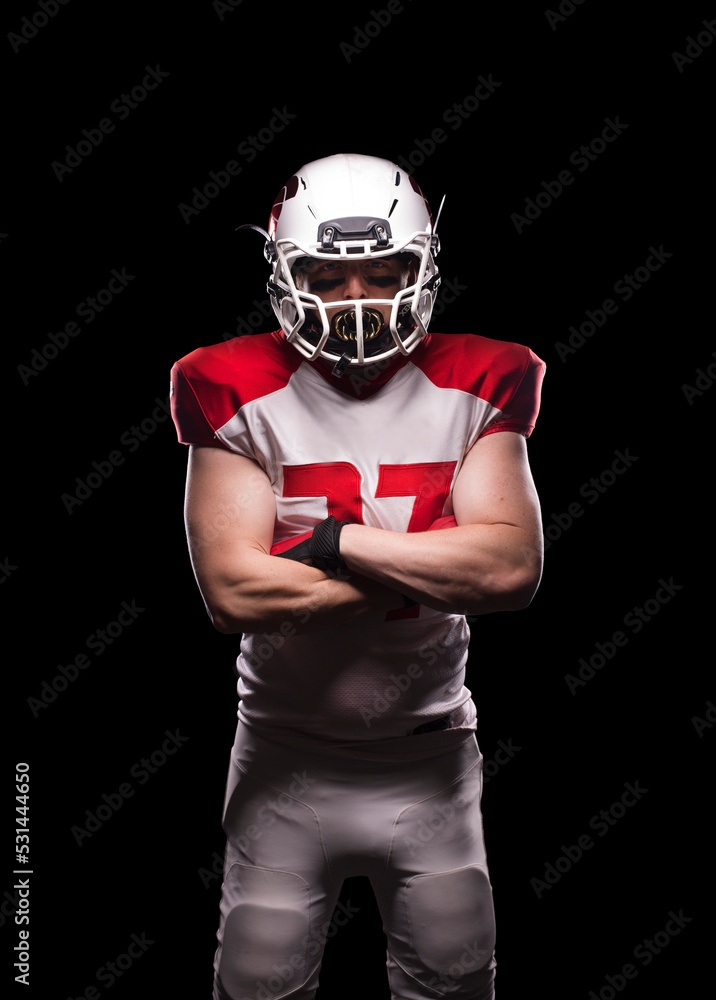 Male American football player crosses his arms in kit.
