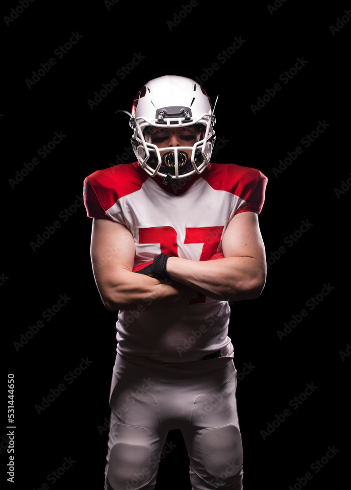 Male American football player crosses his arms in kit. Male American football player crosses his arms in kit.