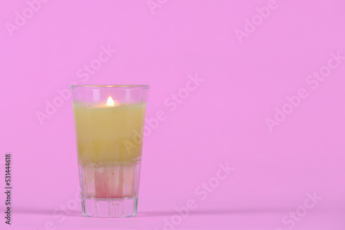 candle.put on a pink background with copy space for design