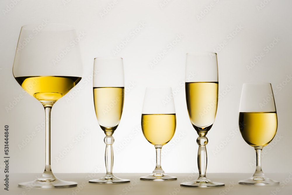 Set of glasses with white wine in series or row. Set of glasses with white wine in series or row.