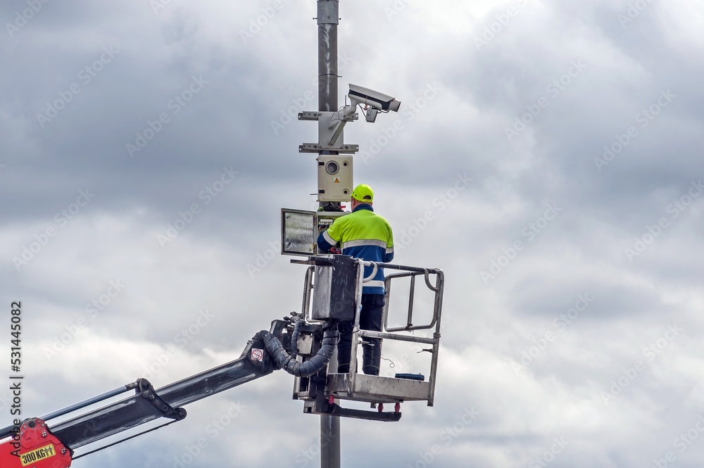 A working installer connects a video camera A working installer connects a video camera