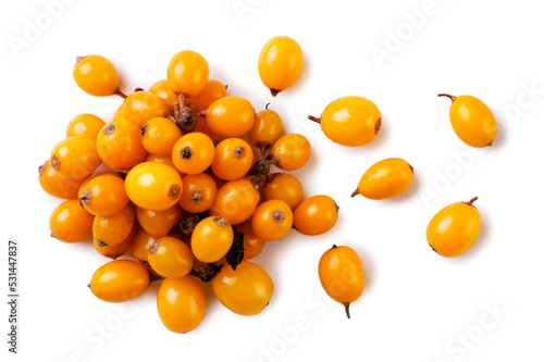 Heap of sea buckthorn and scattered close-up on a white background.