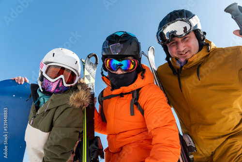 Family vacation on the ski slope. The family is engaged in active sports. Family skiing and snowboarding