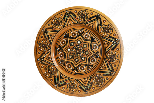 Fotografi Isolated on white wooden souvenir plate with carved and decorated ornament