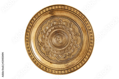Isolated on white wooden souvenir plate with carved and decorated ornament