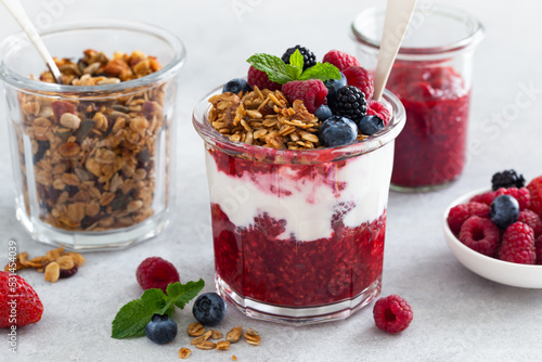 Healthy breakfast, fresh greek yogurt, granola and mixed berries in glass