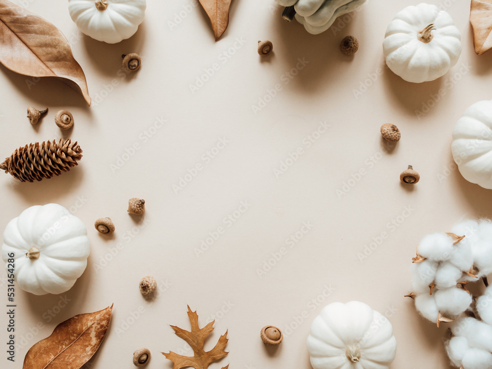 Fall composition with different leaves, pumpkins, acorns on beige background. Fall composition with different leaves, pumpkins, acorns on beige background.