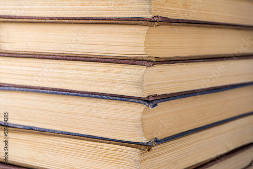 Book background. Stack of books in the library. Old yellow pages of paper books. Learning and knowledge.