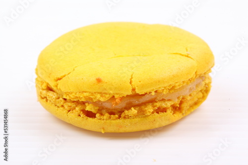 Yellow macaron isolated in white background