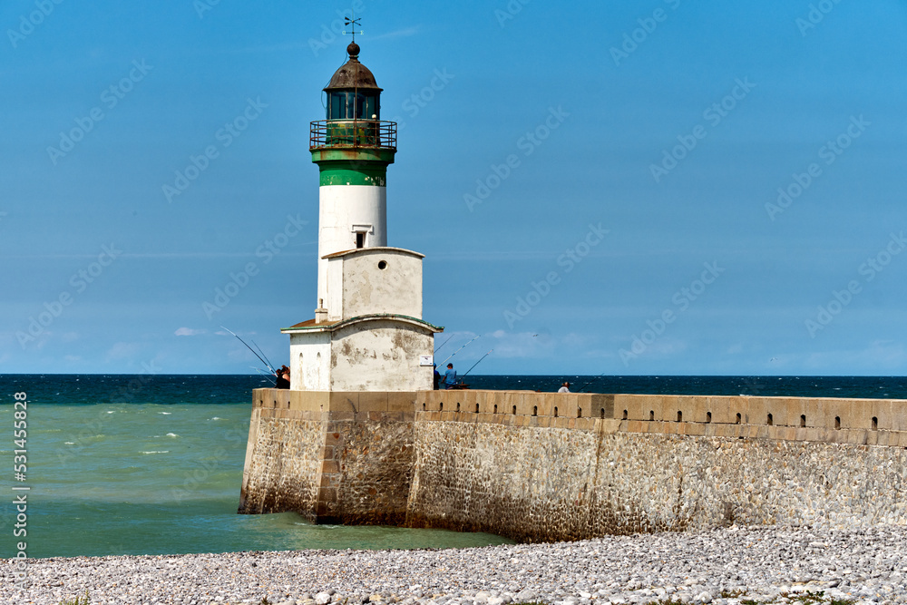 the pebble beach, lighthouse and pier at Le Tréport, Seine-Maritime department in Normandy, France.