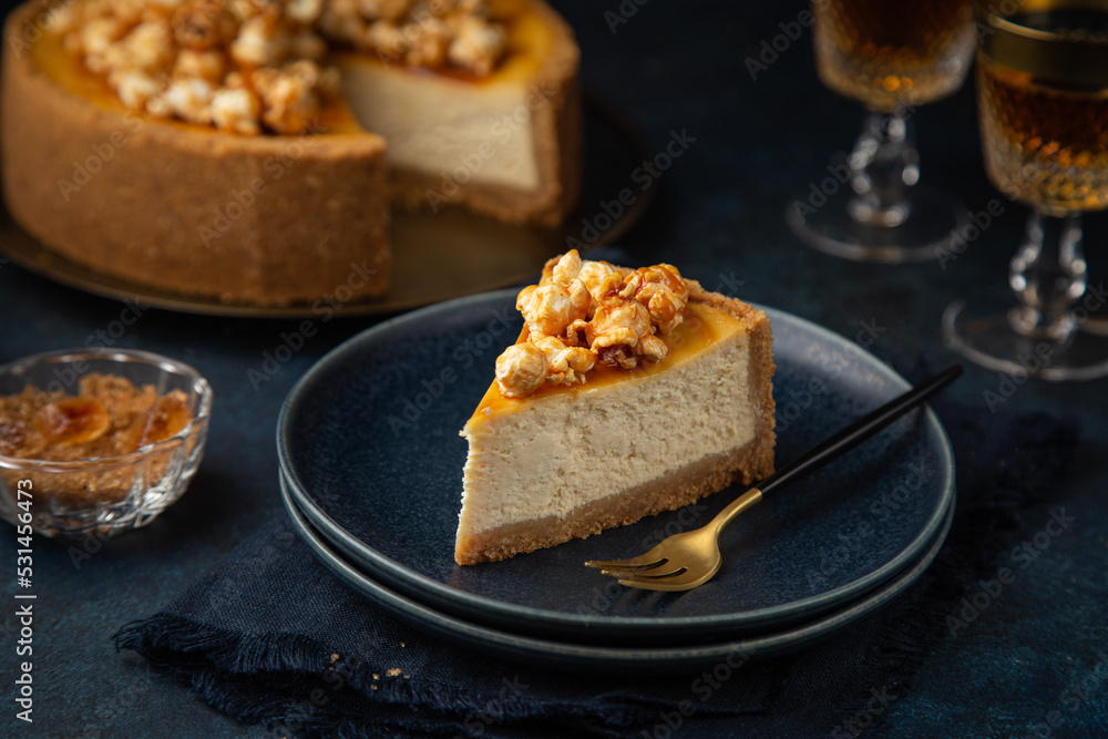 slice of cheesecake with popcorn and salted caramel sauce slice of cheesecake with popcorn and salted caramel sauce
