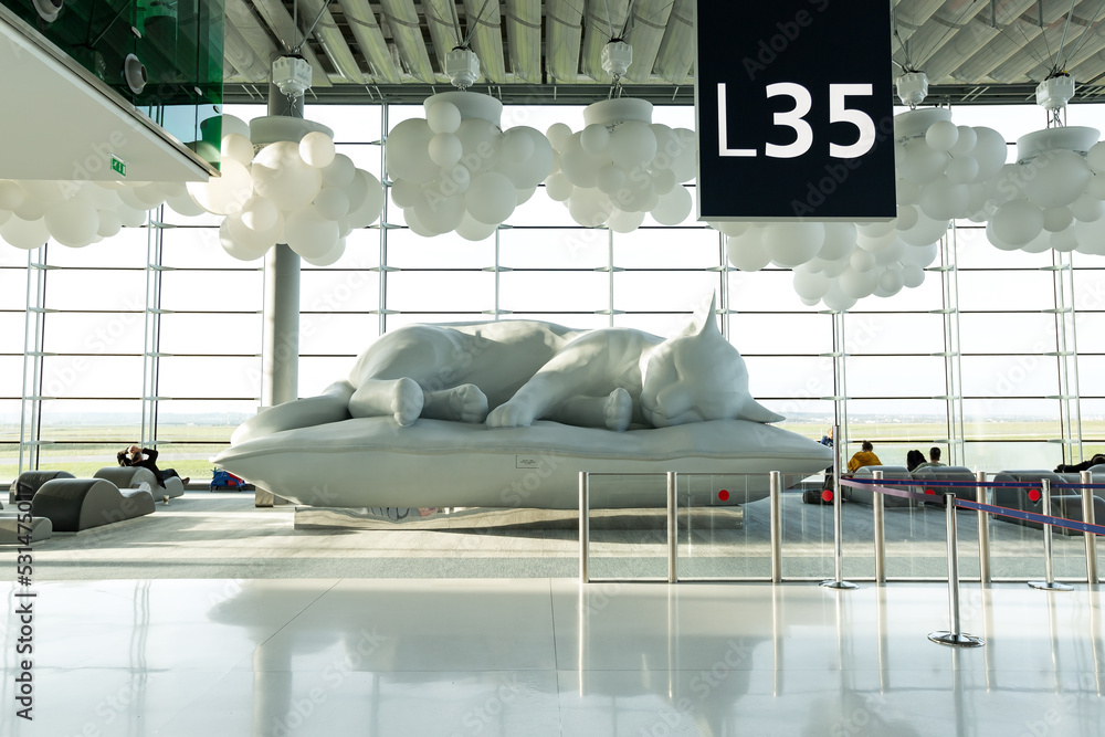 Sculpture of big white cat in terminal of airport Charles de gaulle