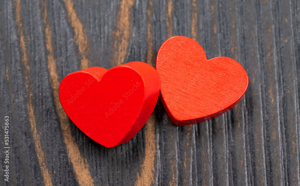 Two red handmade wooden carved hearts on wood background,couple relationship Valentine day concept Two red handmade wooden carved hearts on wood background,couple relationship Valentine day concept