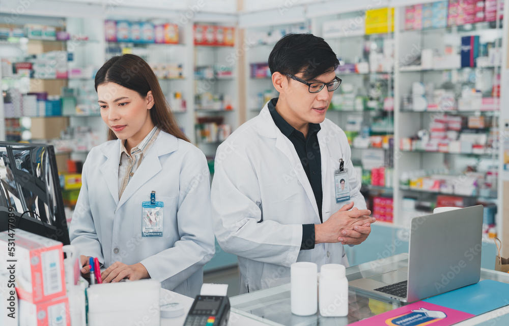 The female and male pharmacists work together as a team at the pharmacy.Pharmacy clinic business,Health care products warehouse service on shelf.doctor holding a prescription.