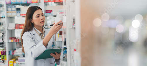 female pharmacist at drugstore.Doctors specializing in medicines.Medical product inventory.female doctor holding a prescription.Health care pharmacists work at the hospital. photo