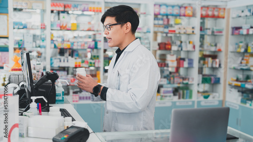 male pharmacist at drugstore.Doctors specializing in medicines.Medical product inventory.male doctor holding a prescription.Health care pharmacists work at the hospital.