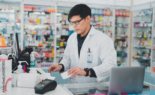 male pharmacist at drugstore.Doctors specializing in medicines.Medical product inventory.male doctor holding a prescription.Health care pharmacists work at the hospital.