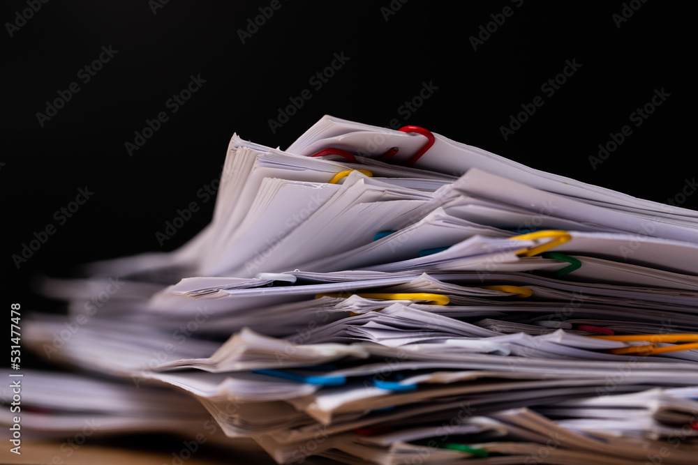 Stack of Group report papers Document on black background. Stack of Group report papers Document on black background.
