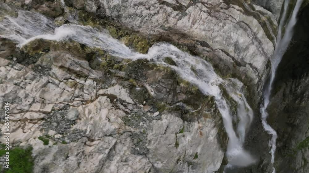 A breathtaking close-up aerial view of the water running along the edge of the picturesque Sofia Waterfall. Karachay-Cherkess Republic. North Caucasus A breathtaking close-up aerial view of the water running along the edge of the picturesque Sofia Waterfall. Karachay-Cherkess Republic. North Caucasus